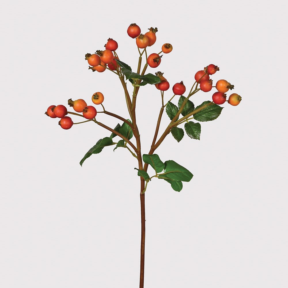 Artificial plant with red berries on a light gray background