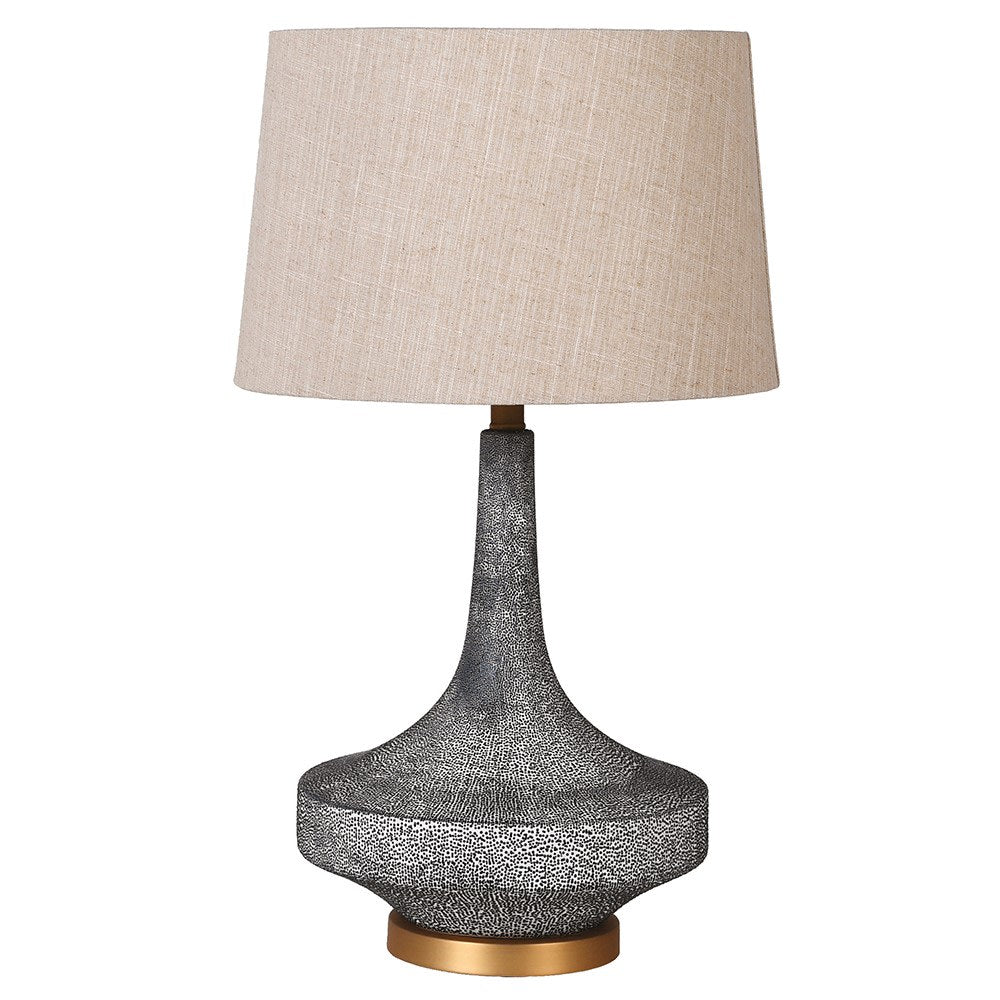 Table lamp with textured gray base and beige lampshade on a white background