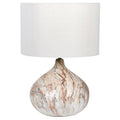 Table lamp with marble base and white shade on a white background