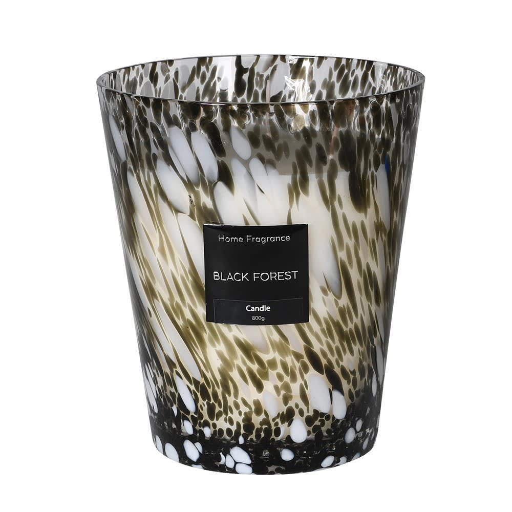 Candle with a patterned container labeled 'Black Forest' on a white background
