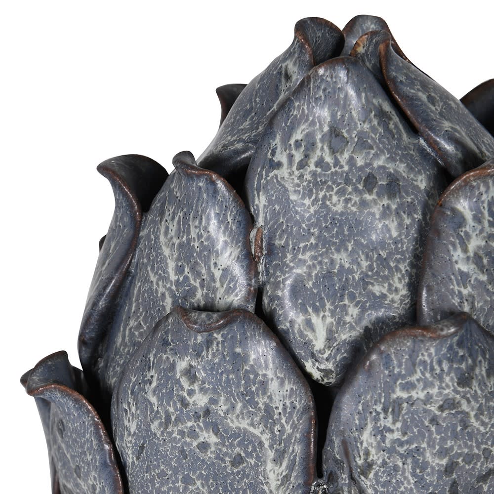 Close-up of a textured ceramic artichoke-shaped vase on a white background