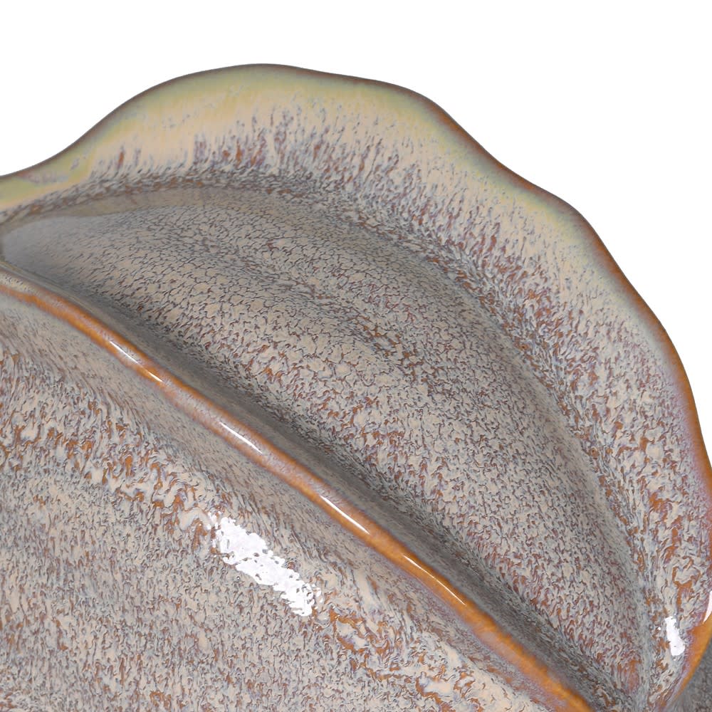 Close-up of a ceramic dish with textured surface and brown rim on a white background