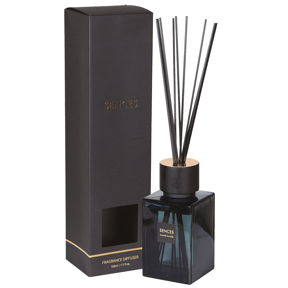 Black fragrance diffuser with reeds and packaging on a white background