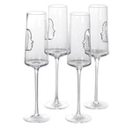 Set of four clear champagne flutes with face outlines on a white background
