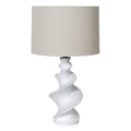 Table lamp with a white spiral base and beige lampshade on a white background